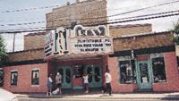 Outside the Island Roxy Theater, a visitor kneels to look at Misty’s hoofprints, placed in the cement during the East Coast premiere of the movie in 1960. 